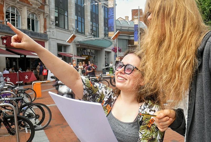 Man and woman playing Professor Pooch’s Adventure in Reading town centre