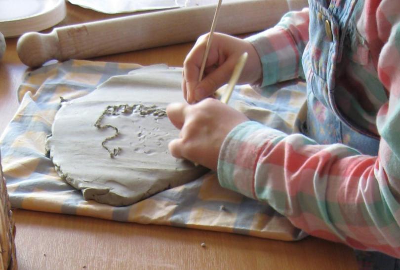 child modelling with clay