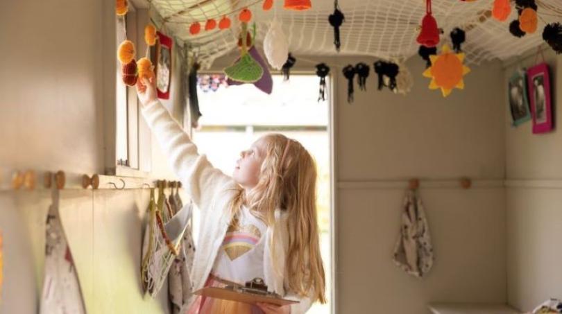 Girl looking at decorations in the Shepherd's Hut at The MERL