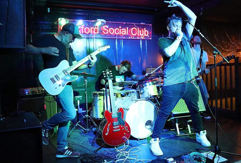 Talk In Code performing on stage at Oakford Social Club