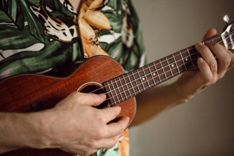 student holding ukulele