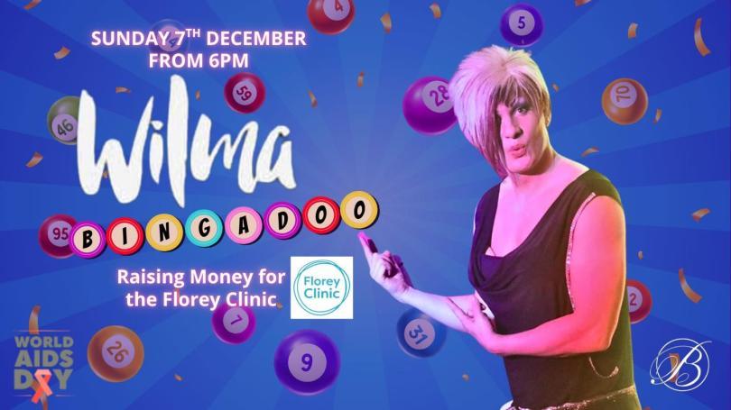 A drag queen and various bingo balls in the background