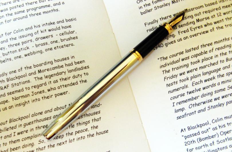 script of a book and pen