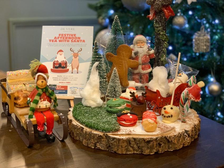 The image shows the children's festive afternoon tea displayed on a sleigh and a log slice.