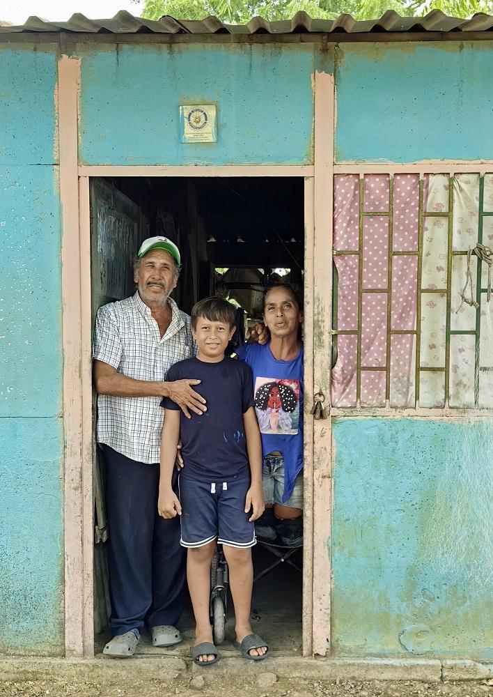 a family stood in the doorway to their home