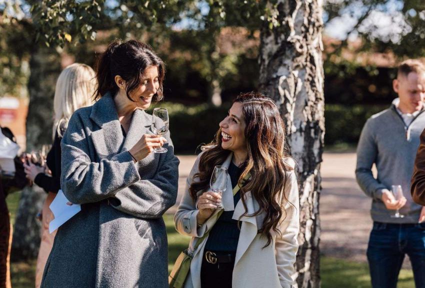 Laughing women with a glass of wine. Outdoors. 