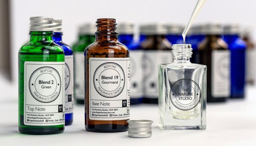 Glass perfume bottles next to an empty perfume atomiser