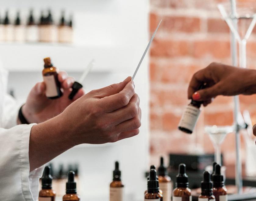 hands with perfume bottles and samplers