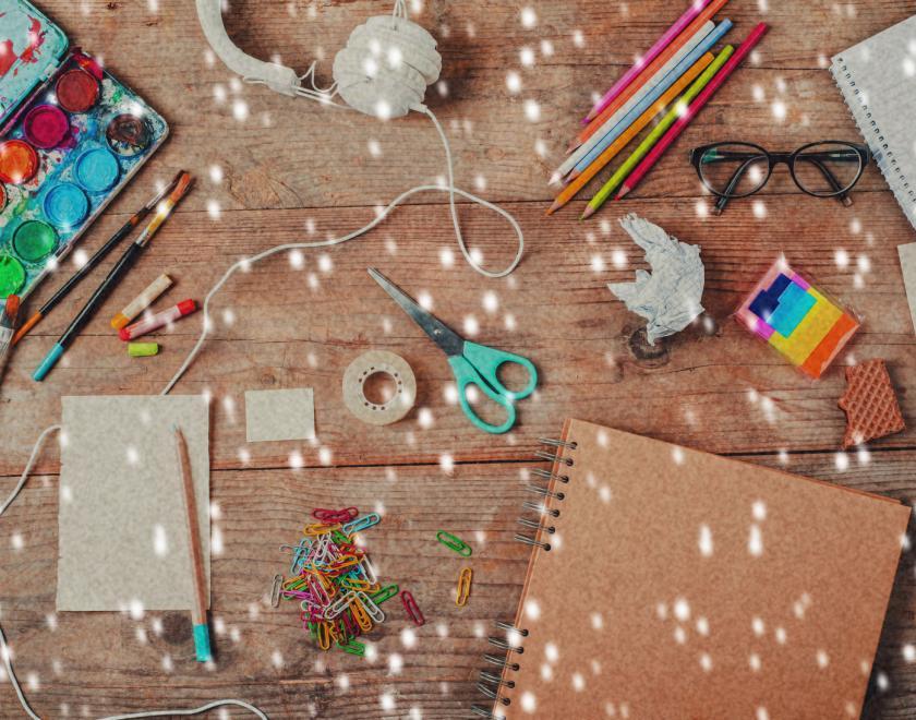 table of art and craft supplies with snowfall effect