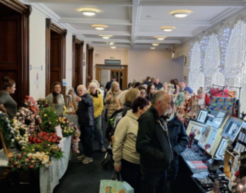 shoppers browsing a Christmas market