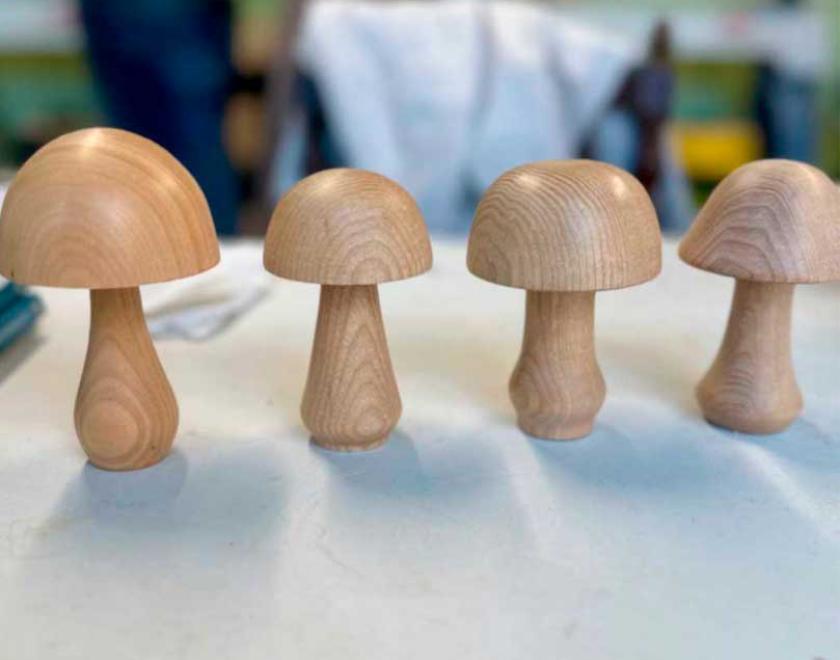 4 slightly different turned wooden mushrooms.