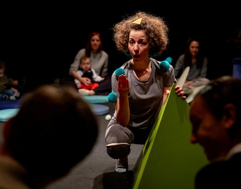 Close-up photo of the performer interacting with the audience members.