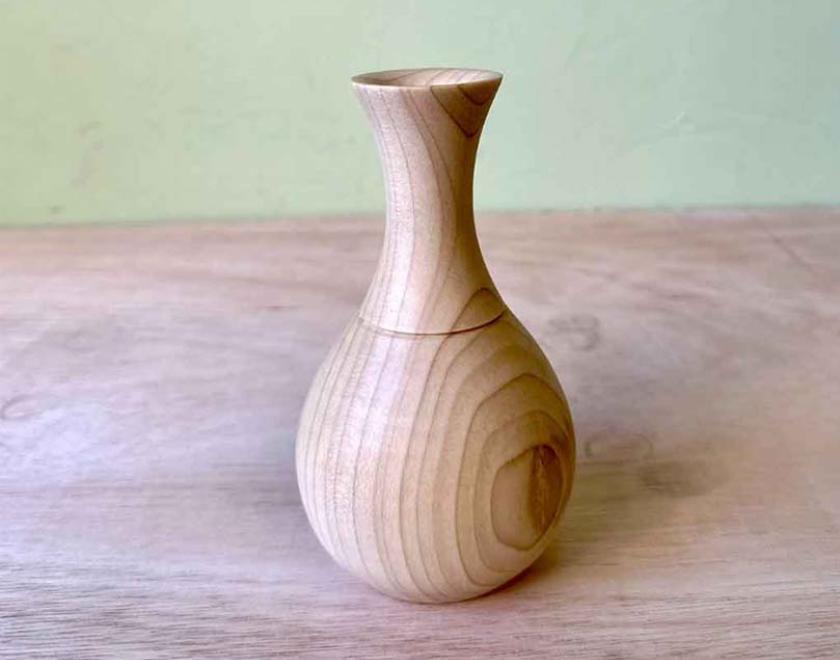 Turned wooden bud vase with glass insert. 