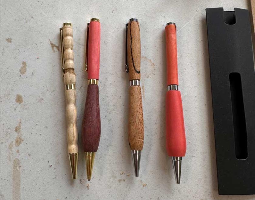 A group of 4 handmade wooden pens.