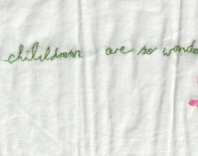 hand embroidery of text and flower. All children are wonderful.