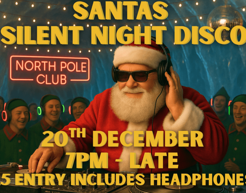 Santa Claus on the DJ decks with a crowd of elves behind him wearing light up head phones
