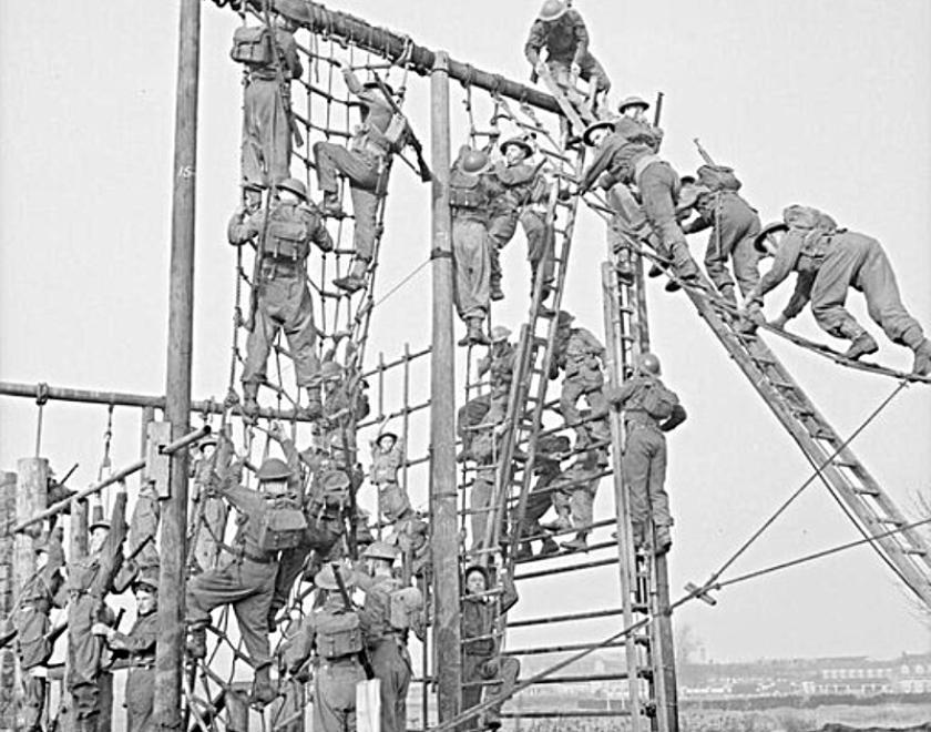 soldiers tacking the nets on an assault course