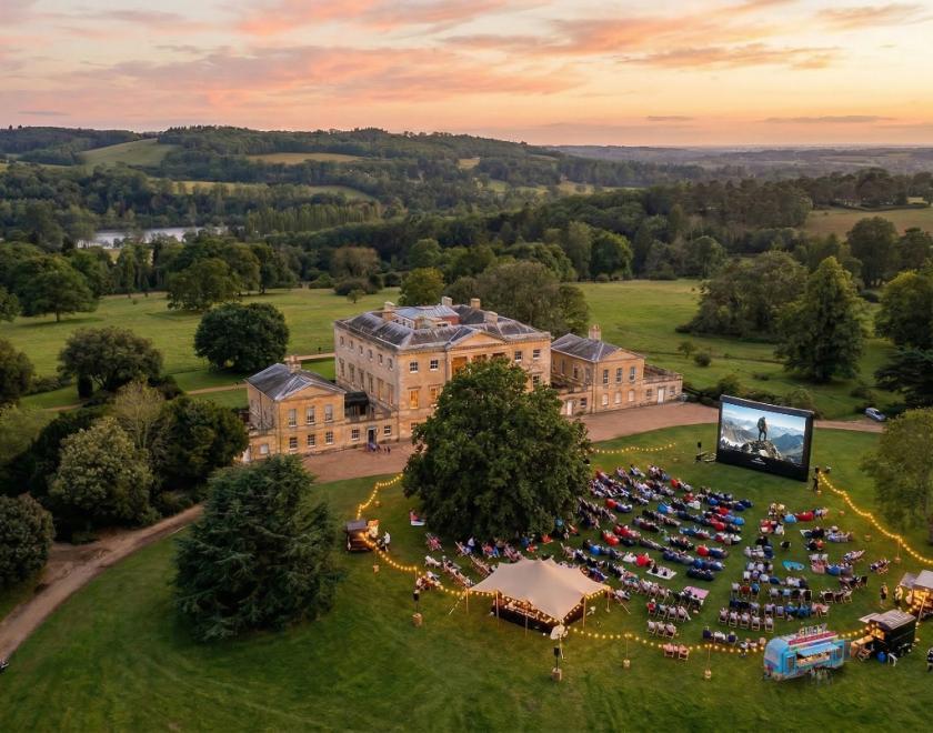 An aerial shot of Basildon Park incorporating the mansion house and parkland with the Outdoor cinema experienced visualised on the front lawn