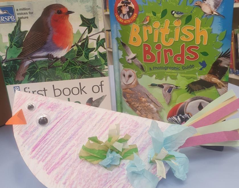 Image of a brightly decorated paper bird. 