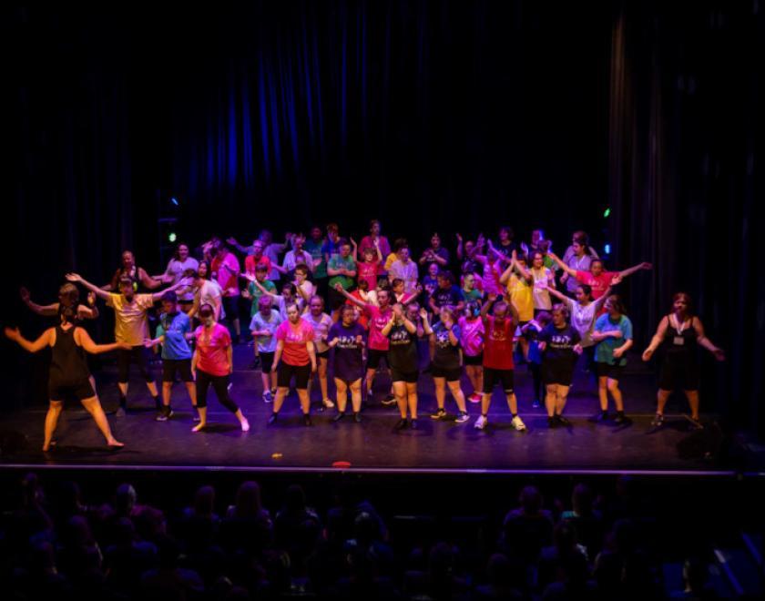 Group of children on stage dancing
