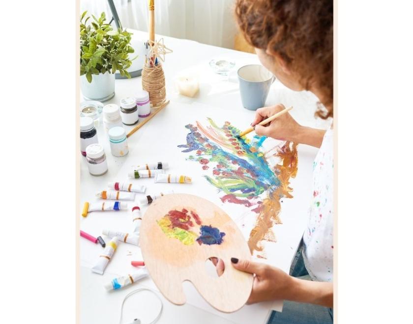 Image of a person using a paintbrush on a canvas