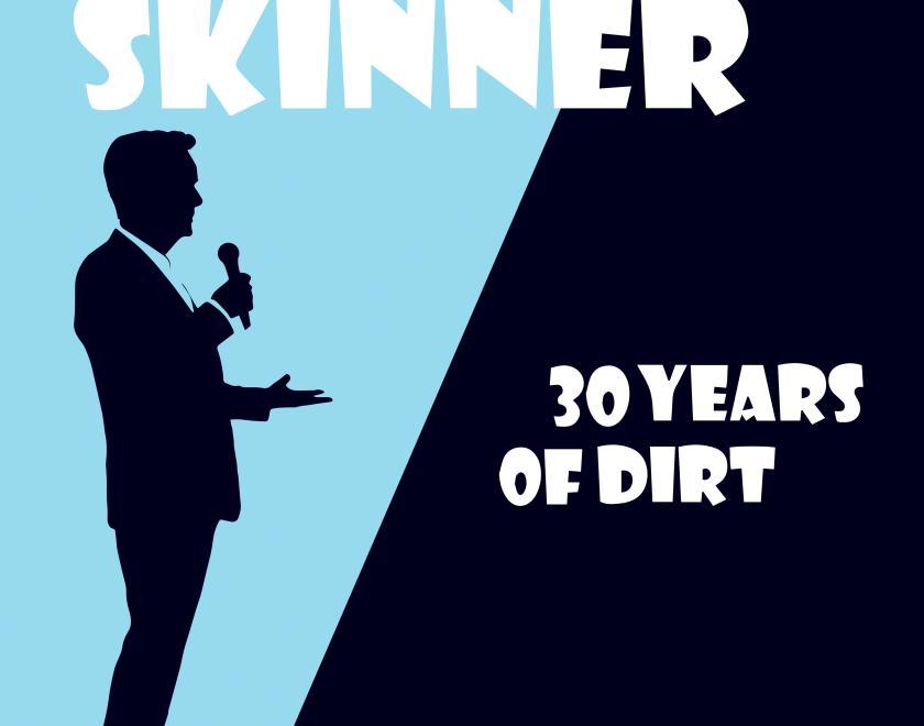 Silhouette of Frank Skinner in a blue spotlight beam