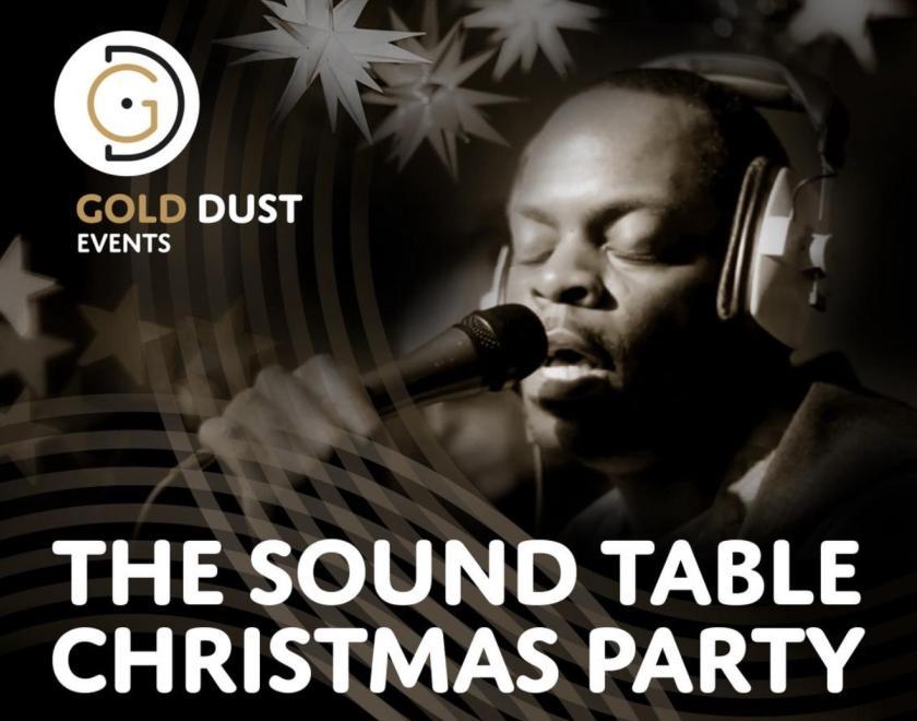 Poster for The Sound Table Christmas Party with a pictire of a man singing wearing headphones