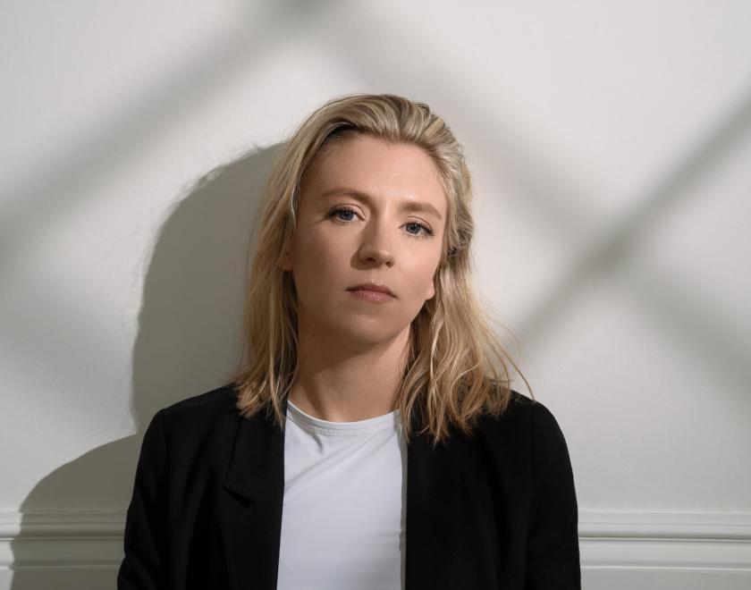 Hannah Scott against white wall