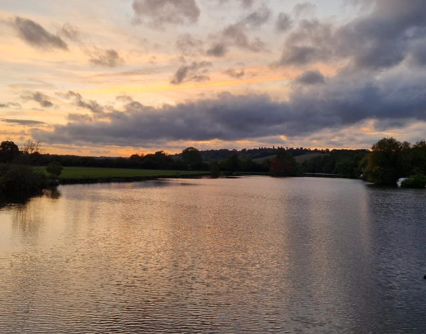 Thames rivercruise boat flag seen and sunset on the river thames