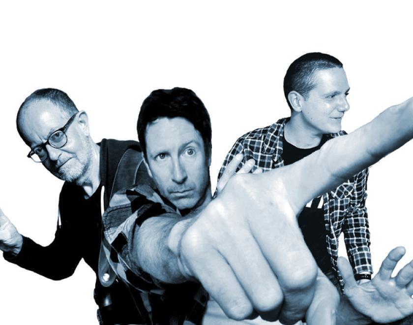 black and white photo of Jon Amor band with some interesting perspective so that the central man's pointing finger is really big