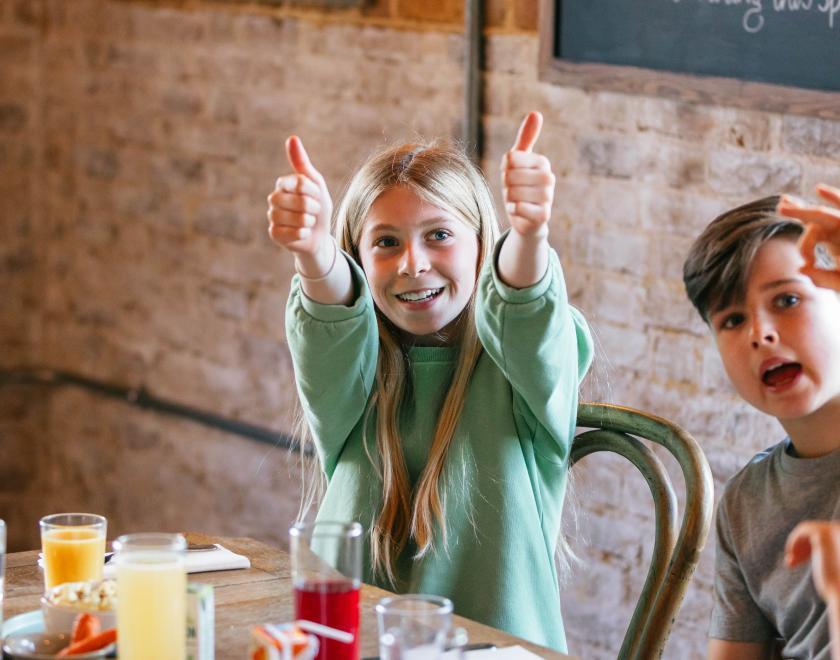 Kids eating pancakes and giving thumbs up