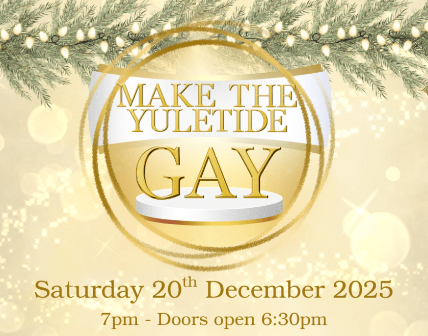 A gold bauble over a gold background with Christmas lights at the top