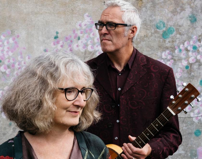 Photo of the duo Milton Hide.  Jim Tipler and Jo Church are posing for the photograph with Jim holding a guitar.
