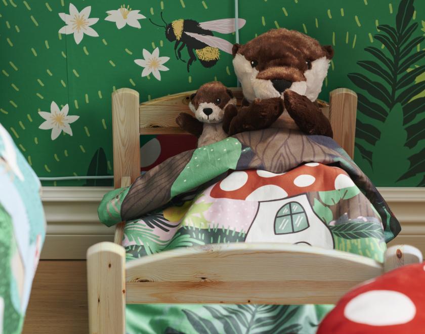 Mother and baby otter sat in bed 