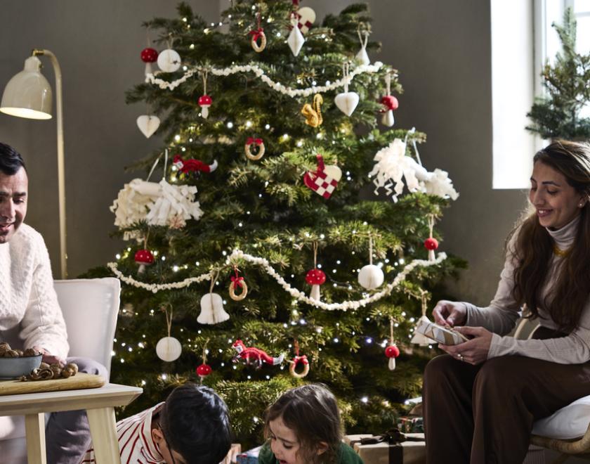Family gathered around christmas tree