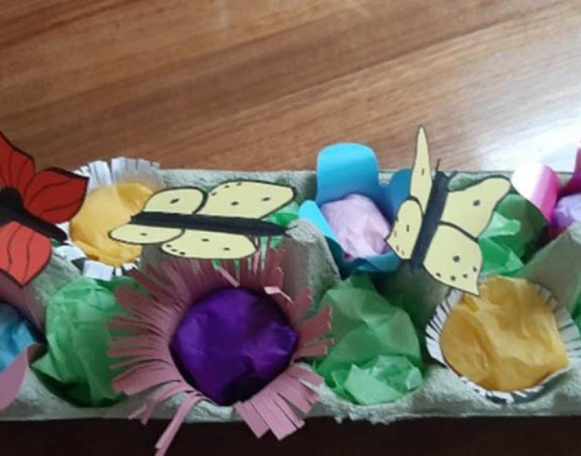 Photograph of an egg box filled with handmade crafted flowers