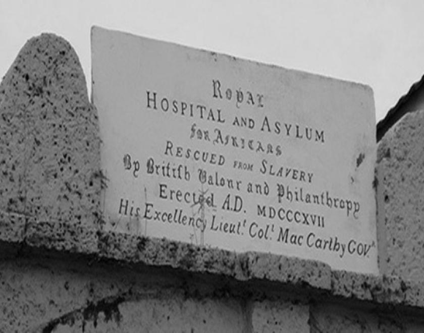 Inscription stone above the gateway to The King's Yard, Freetown, Sierra Leone reads "ROYAL ASYLUM AND HOSPITAL FOR THE AFRICANS RESCUED FROM SLAVERY BY BRITISH VALOUR AND PHILANTHROPY"