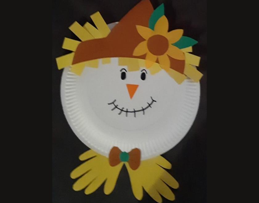 Photograph of a scarecrow's face made from a paper plate