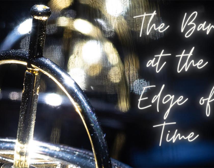 Close-up photograph of a shiny silver metal object. There is a row of identical objects in the background, out of focus. To the right of the object is text overlaid onto the image, it is white and glowing like a neon sign. Text reads 'The Bar at the Edge of Time'