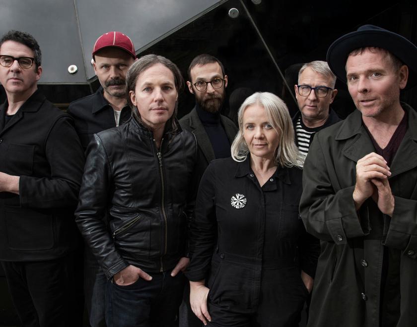 Members of the band Belle and Sebastian wearing black and charcoal clothes