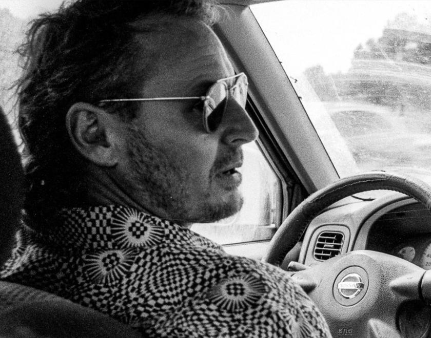 Singer Ben Howard wearing sunglasses at the wheel of a car