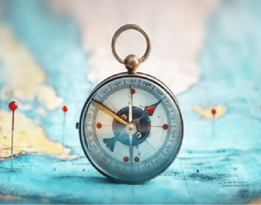 Image of a map with pins marking places. In the centre of the map is a compass.