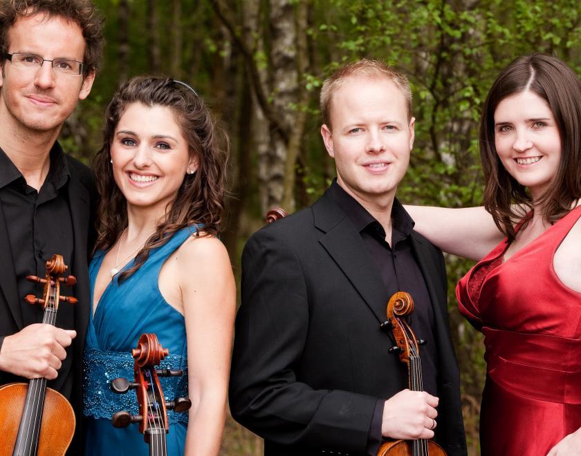 members of the quartet lined up with instruments