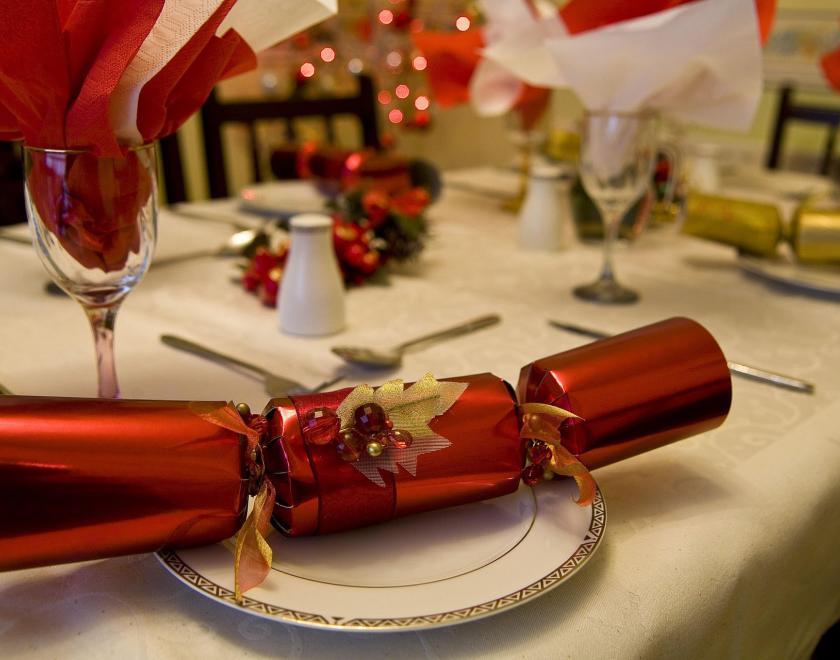a laid Christmas table with crackers