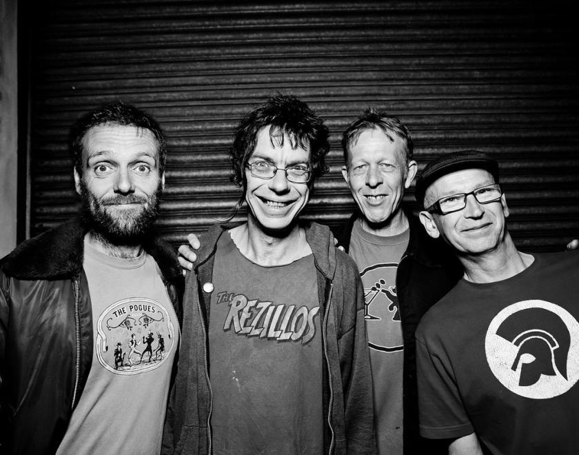 Four middle-aged punks in black and white