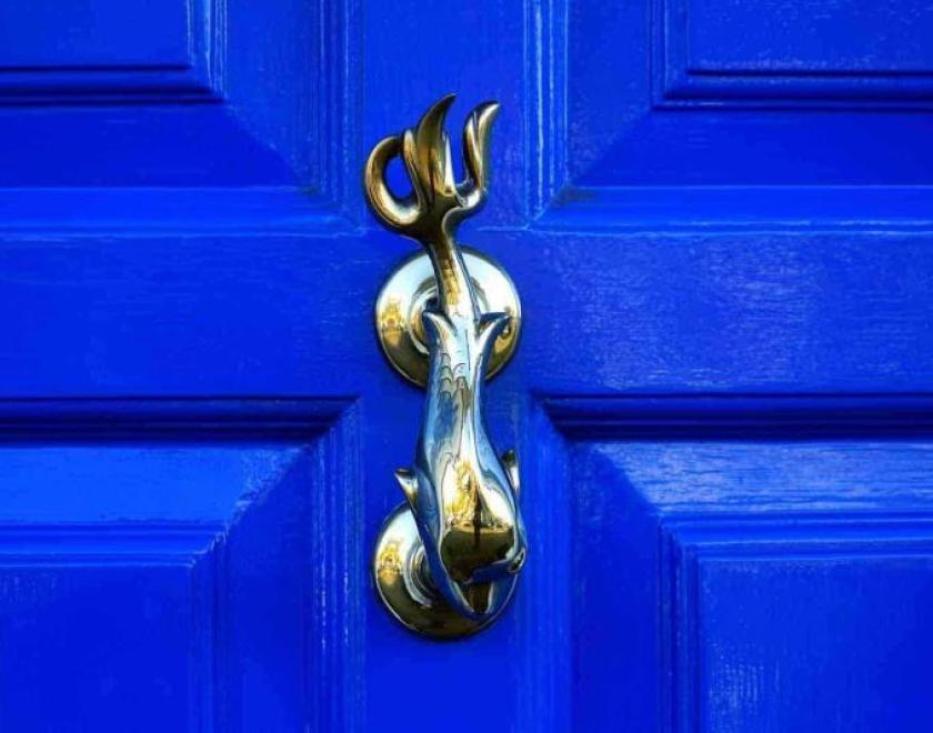 a blue door with knocker