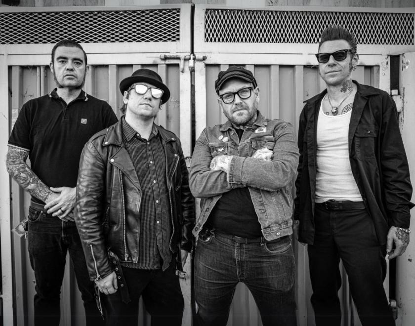 four middle-aged punks in black and white