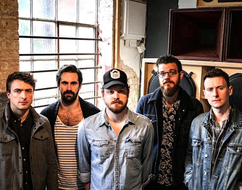 five beared men in denim shirts and leather jackets
