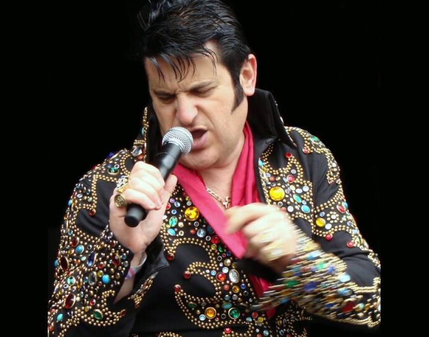 Man dressed as Elvis in a sparkly jumpsuit
