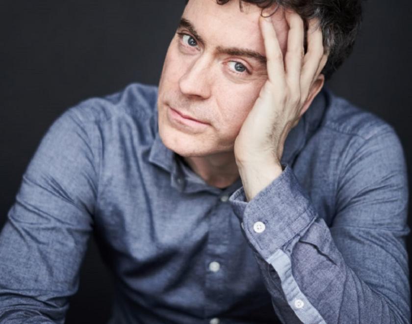 Paul Lewis leaning his head on one hand